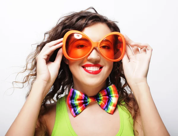 Playful young woman with party glasses. — Stock Photo, Image