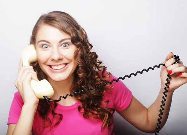 Beautiful curly woman  talking on white vintage telephone — Stock Photo, Image