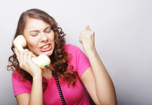 Beautiful curly woman  talking on white vintage telephone — Stock Photo, Image