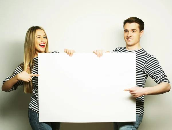 Couple holding a banner — Stock Photo, Image