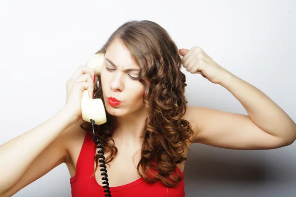 Beautiful curly woman  talking on white vintage telephone — Stock Photo, Image