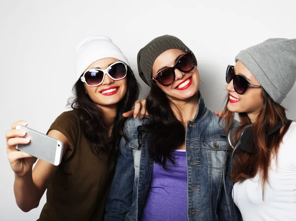 Tres chicas adolescentes felices con teléfono inteligente tomando selfie — Foto de Stock