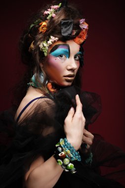 Parlak yaratıcı makyajlı genç kadın.