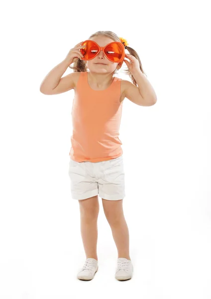 Little girl with fun orange carnaval glasses — Stock Photo, Image