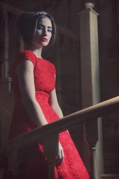 Kobieta w eleganckiej sukience pozowanie na schodach — Zdjęcie stockowe