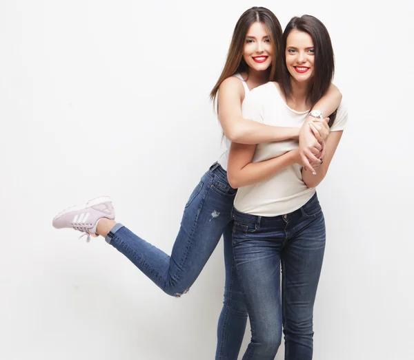 Two young girl friends standing together and having fun. — Stock Photo, Image