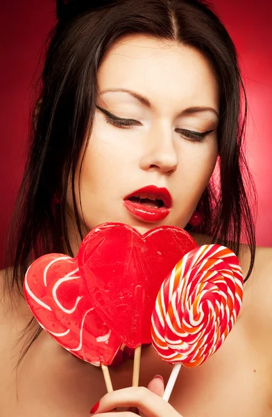 Pretty young woman holding lolly pop. — Stock Photo, Image