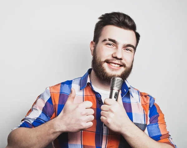 Young singer with microphone — Stock Photo, Image