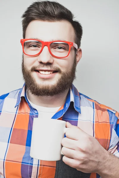 Skægget mand med en kop kaffe - Stock-foto