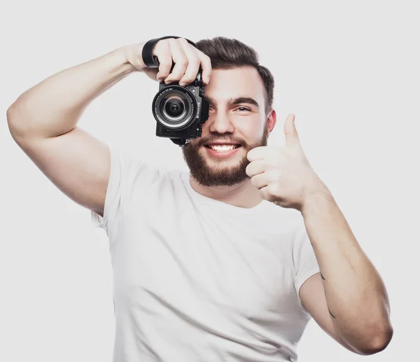 Young bearded photographer taking pictures with digital camera. — Stock Photo, Image