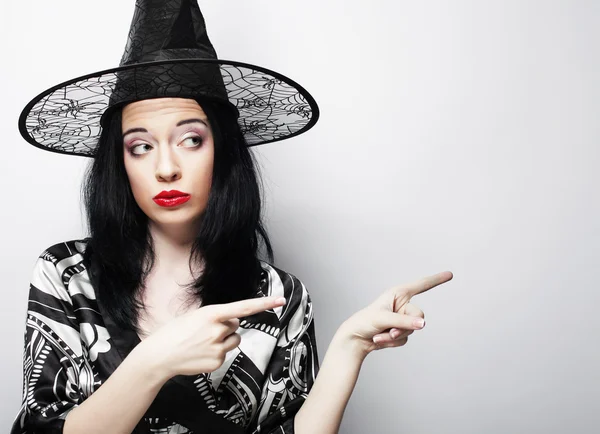 Pretty young brunette witch with black hat — Stock Photo, Image