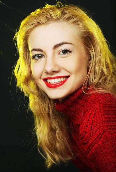 Smiling blonde in red sweater — Stock Photo, Image