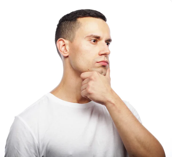 Portrait of handsome young thoughtful man isolated over white ba — Stock Photo, Image