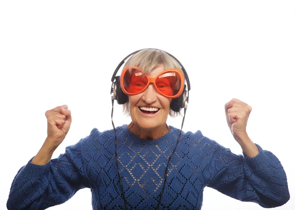 Funny old lady listening music and showing thumbs up. — Stock Photo, Image