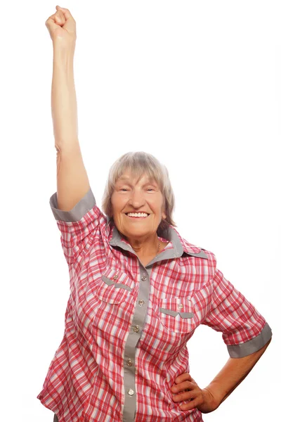 Vrolijke senior vrouw gebaren overwinning op een witte achtergrond — Stockfoto