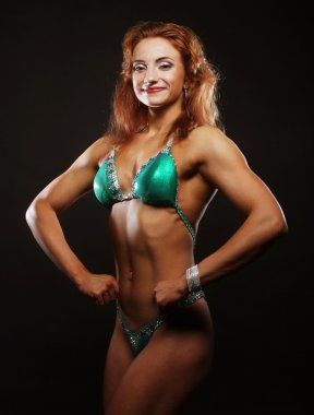 Siyah arka planda bikinili sarışın kadın.