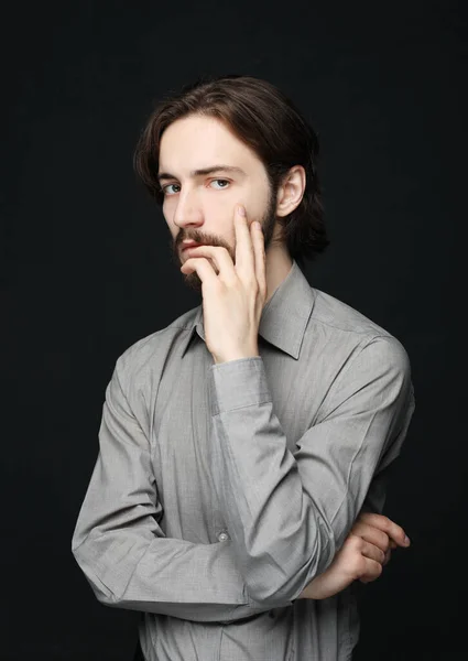 Unhappy man touching his forehead over black background — Stock Photo, Image