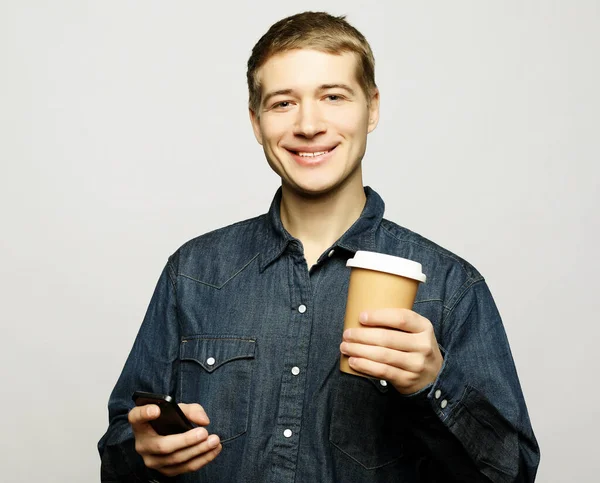 Portrait of happy man talking on phone and drinking coffee — Stock Photo, Image