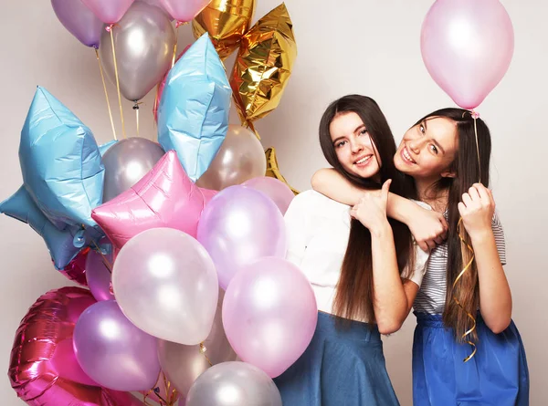 Lifestyle and people concept: two girls friends with colorfoul air balloons - young and happy. — Stock Photo, Image