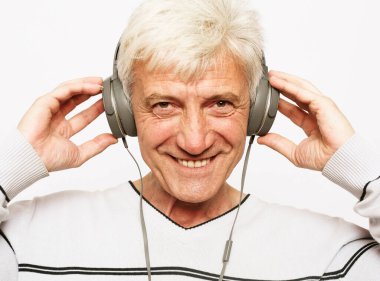 Yaşlı adam kulaklıkla müzik dinliyor..