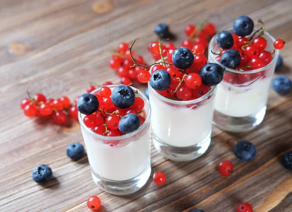 Gesundes Frühstück - Joghurt mit frischen Beeren im Glas, auf Holzgrund — Stockfoto