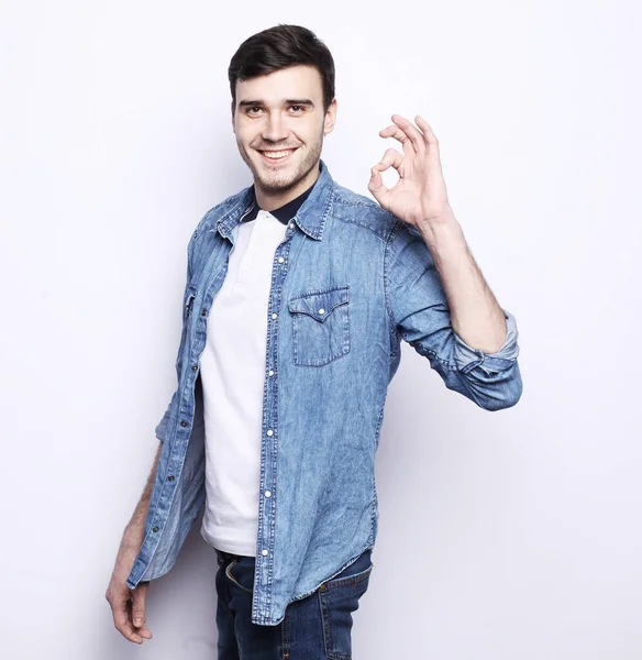 Lifestyle and people concept: Happy handsome man wearing casual showing ok — Stock Photo, Image
