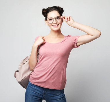 Sırt çantalı mutlu, tatlı, esmer kız öğrenci. Güzel kadın turist. Okuma ya da seyahat.