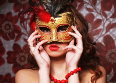 Uzun kıvırcık saçlı, maskeli esmer kadın. Parti için hazır..