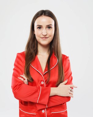 charming girl with long hair wearing red pajamas over white background