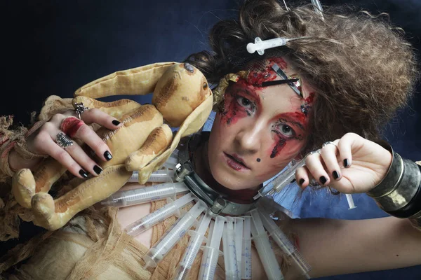 Mujer joven con maquillaje creativo sosteniendo conejito. Tema Halloween. — Foto de Stock