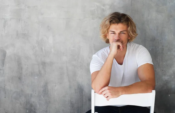 Stylish fashion man model sitting on the chair — Stock Photo, Image