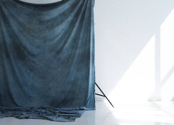 blue studio fabric background on racks
