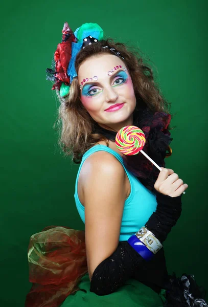 Young woman with creative make-up holds lollipop. Doll style. — Stock Photo, Image