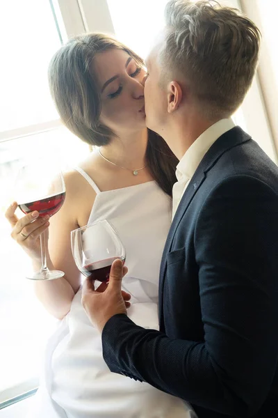 Newlyweds in love hug, kiss and drink wine, happiness and anticipation of a happy life — Stock Photo, Image