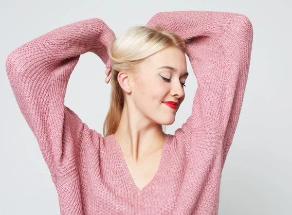 Close up portrait of young happy blond woman on grey background — Stock Photo, Image