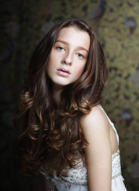 Uzun dalgalı ve parlak saçlı güzel bir kadın. Kıvırcık saçlı, beyaz elbiseli sarışın kadın..