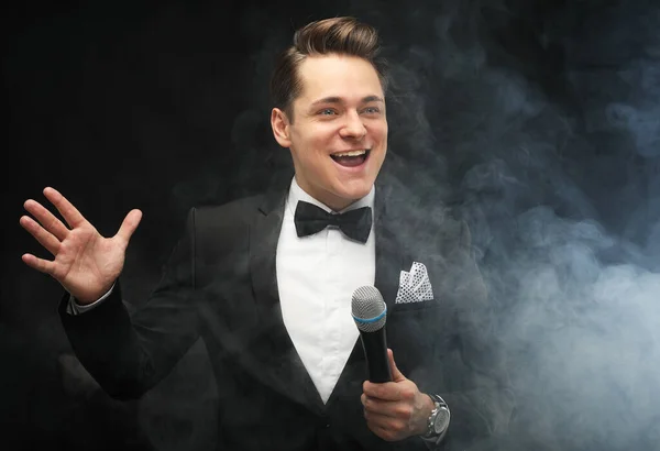 Stylish Young Man Tuxedo Holding Microphone Posing Dark Background Smoke — Stock Photo, Image