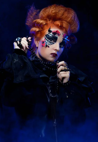 Red-haired young woman in witch costume. Creative makeup for masquerade. — Stock Photo, Image