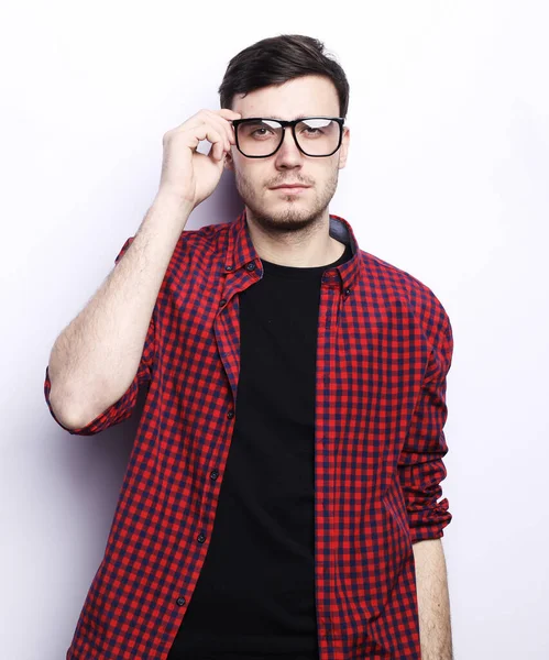 Lifestyle and people concept: young man in glasses, thoughtful, touches glasses, reflects, making a decision. — Stock Photo, Image