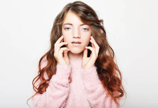 People, childhood and fashion concept: little girl child wearing pink sweater over white background, close up — Stock Photo, Image