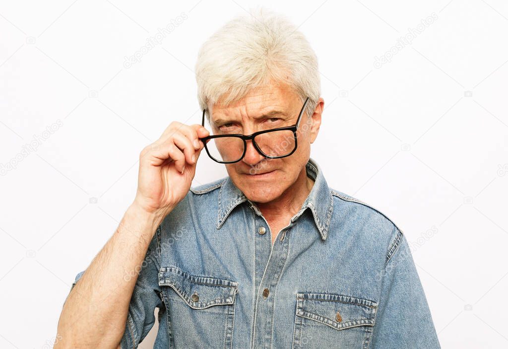 old age, problem and people concept, close up of senior man in glasses thinking over white background