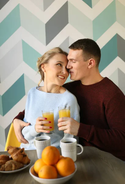 Lifestyle and people concept: Young happy lovely couple have breakfast in the early morning at home, hug, smile. — Stock Photo, Image