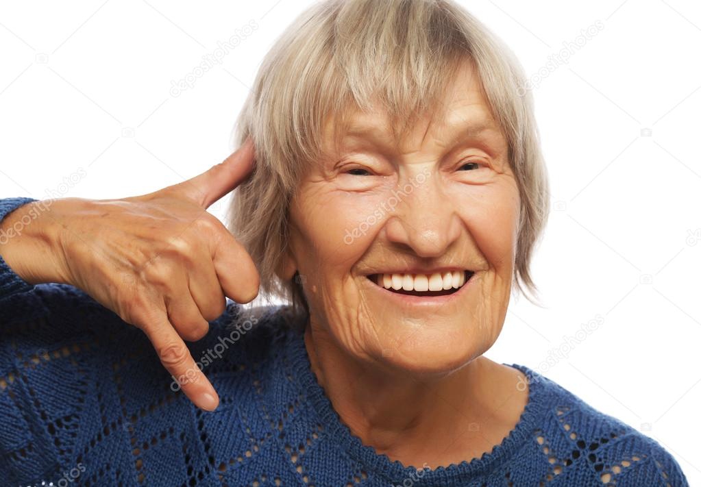 senior happy woman is making a call me gesture