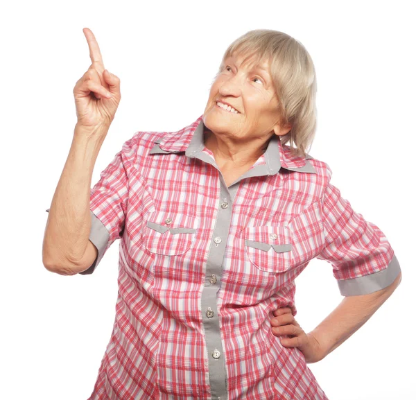 Happy senior woman pointing upwards — Stock Photo, Image