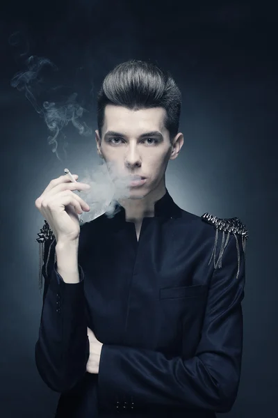 Young stylish man smoking a cigarette — Stock Photo, Image