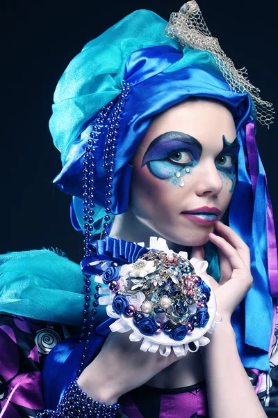 Woman with creative make up holding a bouquet of jewelry — Stock Photo, Image