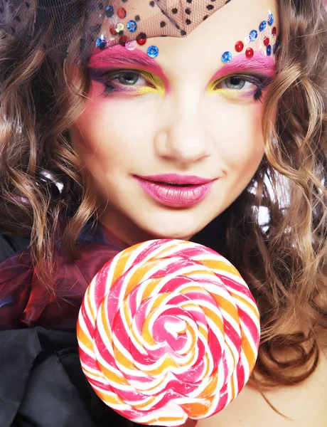 Girl with with creative make-up holds lollipop. — Stock Photo, Image