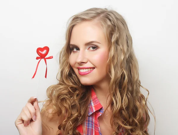 Happy blond woman with little red heart — Stock Photo, Image