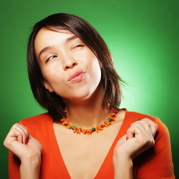 Young expression woman over green background — Stock Photo, Image