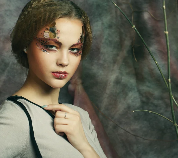 Mujer con maquillaje brillante con ramas secas — Foto de Stock